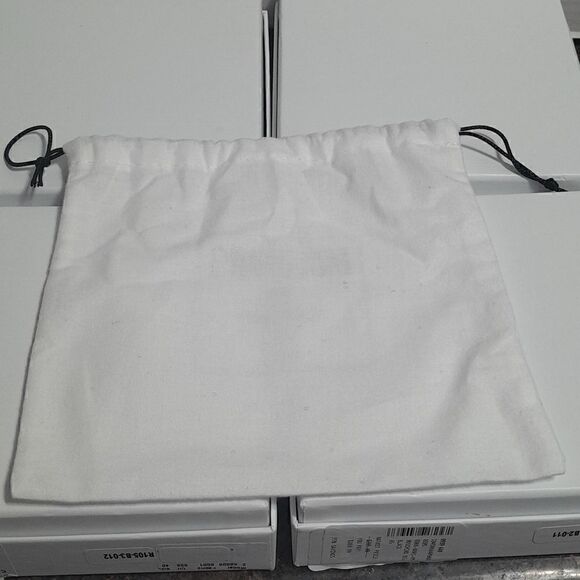 4 Moschino Deluxe Boxes, 4 Deluxe Dust Bags, and 1 and one Enclosure.
